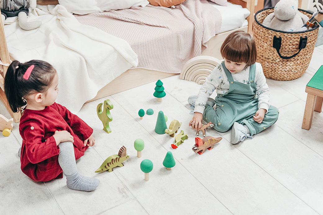 Two girls are playing with toys