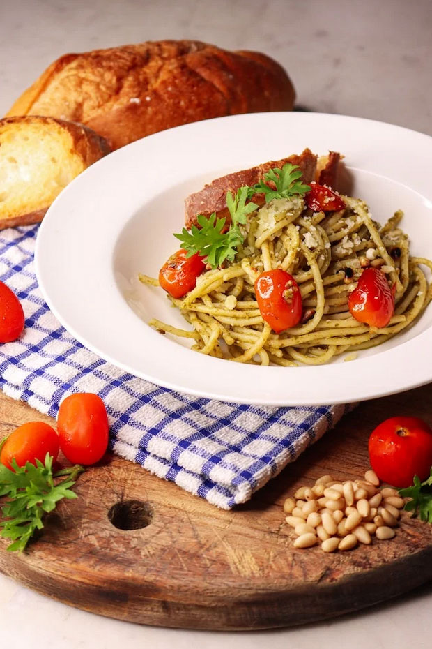 spaghetti with pesto sauce and cherry tomatoes.