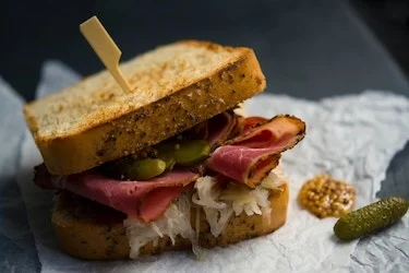 a Reuben sandwich on wax paper. 